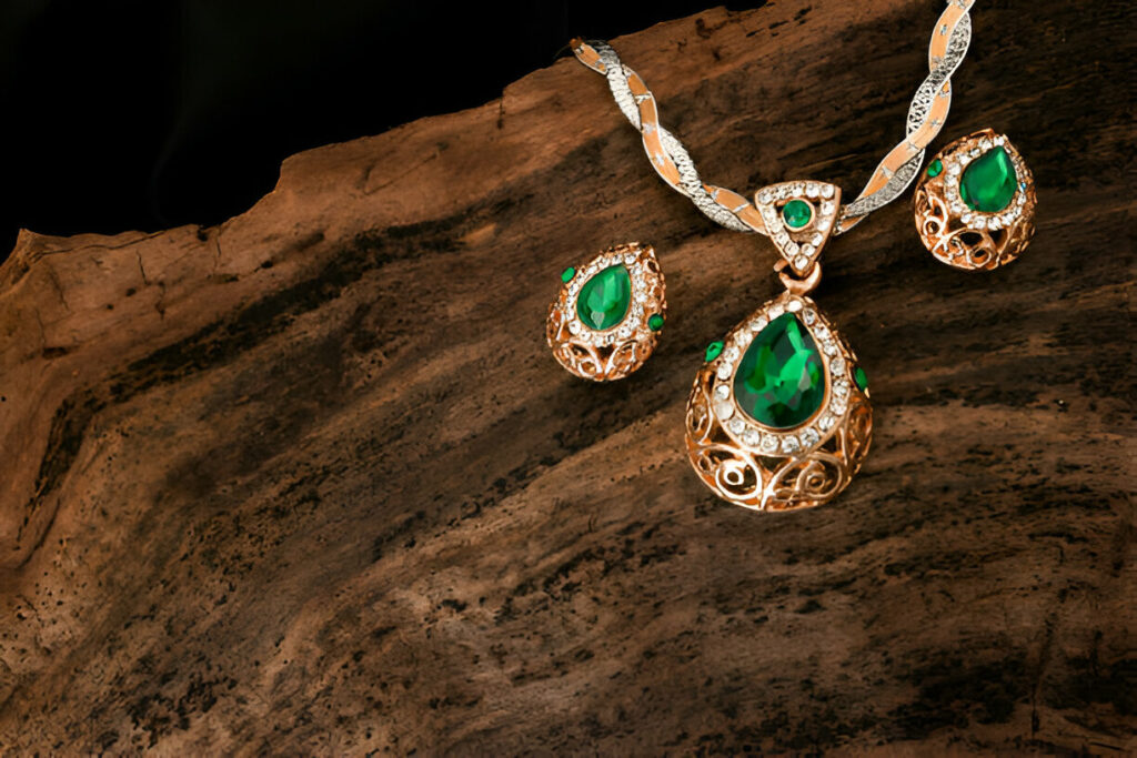 beautiful emerald stone earrings on wooden background